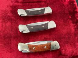Trio of Vintage Buck Folding Pocket Knives, 505 Knight, wooden handles