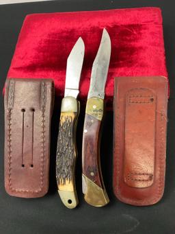 Pair of Schrade Folding Pocket Knives, models 127UH & LB7 w/ Leather Sheaths