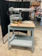 Delta Model 10" Deluxe Arm Saw W/ Automatic Blade on metal rolling table - Develops over 2HP