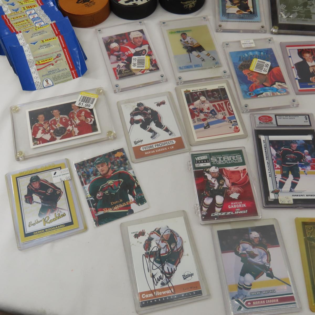 Collectible hockey cards and hockey pucks.