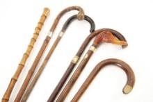 Collection of Six Canes, one is a Walking Stick, each one has an approximately 34" long shaft. One o