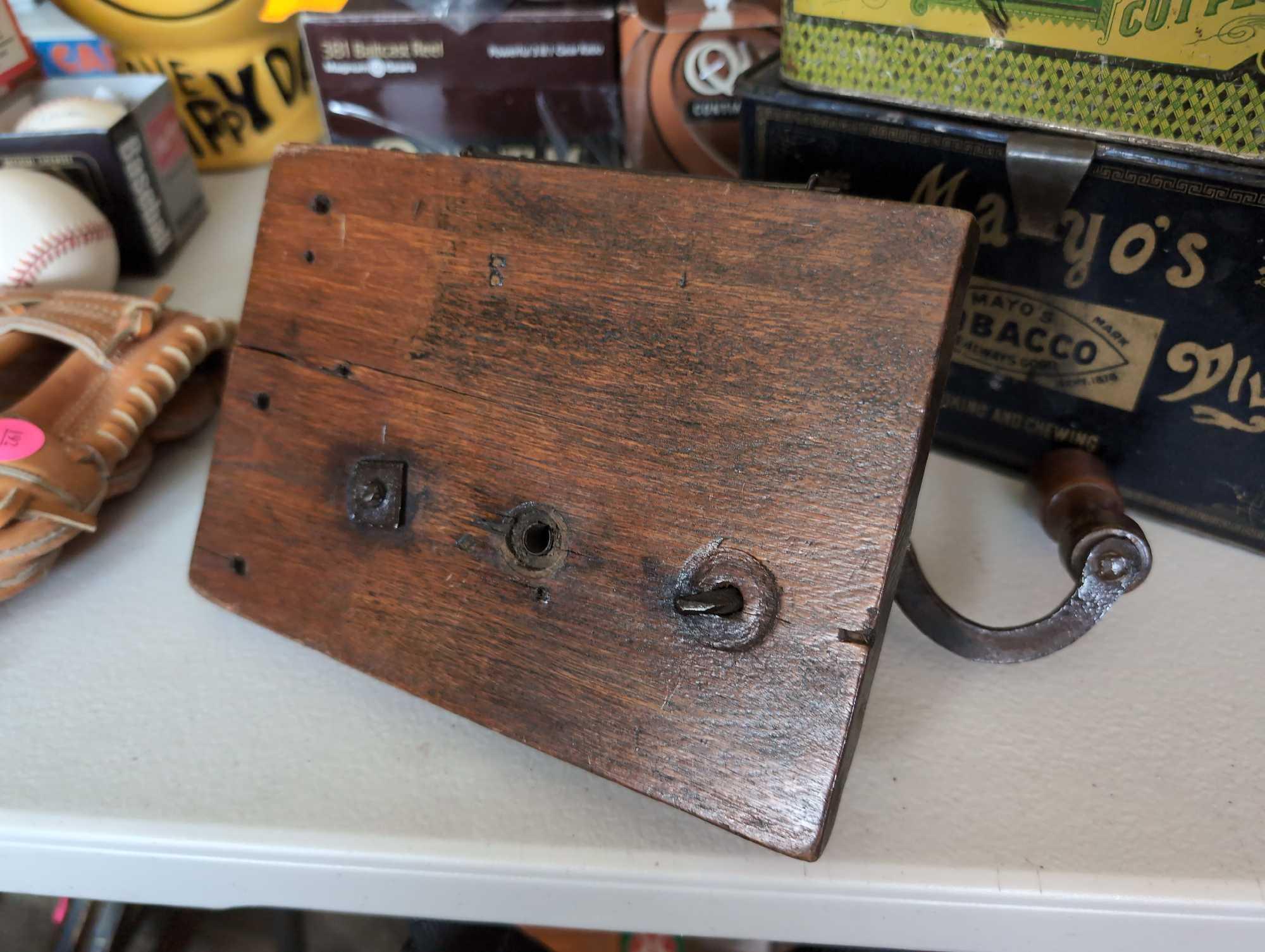 (LR) ANTIQUE CRANK COFFEE GRINDER ATTACHED TO A WOODEN WALL PLAQUE. 8" X 10".