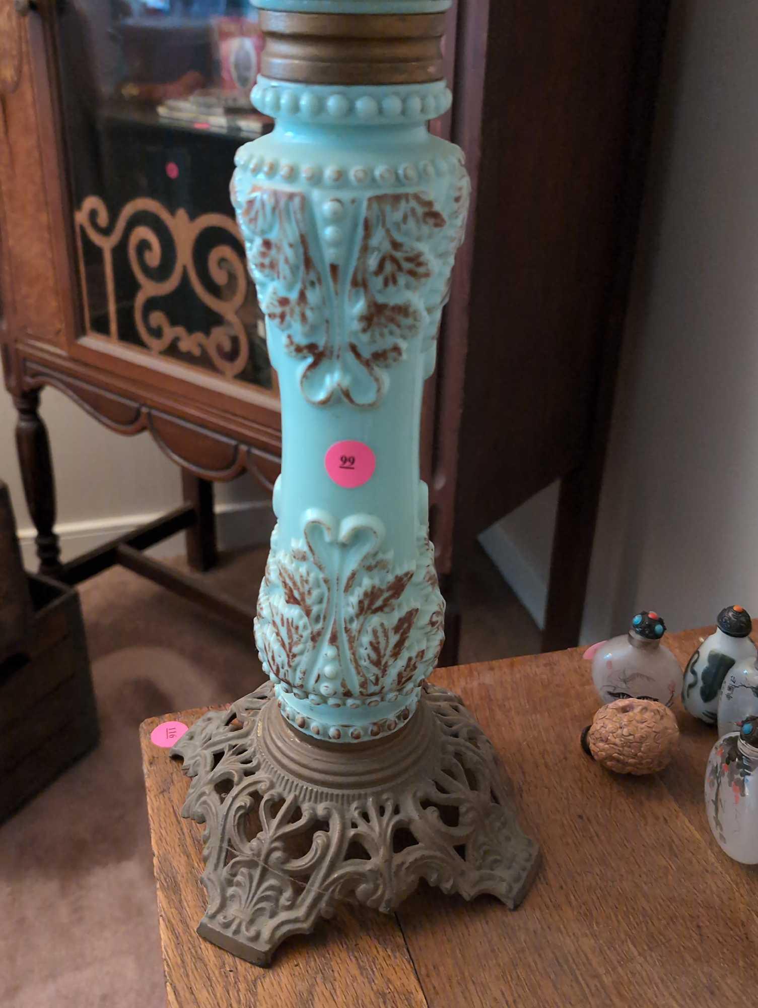 (LR) ANTIQUE CELADON GREEN GLASS LAMP WITH BROWN LEAF ACCENTS, STANDS ON A METAL BASE. IT MEASURES