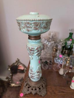 (LR) ANTIQUE CELADON GREEN GLASS LAMP WITH BROWN LEAF ACCENTS, STANDS ON A METAL BASE. IT MEASURES