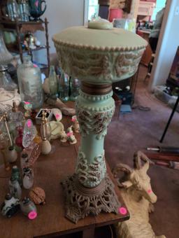 (LR) ANTIQUE CELADON GREEN GLASS LAMP WITH BROWN LEAF ACCENTS, STANDS ON A METAL BASE. IT MEASURES