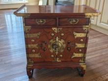 LATE 19TH CENTURY KOREAN BRASS ACCENTED SIDE TABLE/CABINET. FEATURES TWO DRAWERS AT THE TOP AND TWO