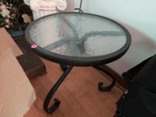 (LR) ROUND BLACK METAL AND TEMPERED GLASS PATIO SIDE TABLE. IT MEASURES 16" DIA X 17"T.