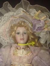 (GAR) Aden Keepsake Porcelain Doll with Blonde Hair and Blue Eyes Wearing a Purple Dress with