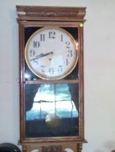 (SBD) 16" W x 4" D x 36" H Oak Regulator Wall Clock. Damage to glass as noted in photo. Sold as-is.