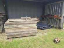 CONTENTS OF SHED BAY: ASSORTED LUMBER, PARTIAL PALLET OF CEMENT SUPPORT EQUIPMENT