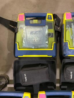 4 CARDIAC SCIENCE AUTOMATED EXTERNAL DEFIBRILLATORS & 1...CARDIAC SCIENCE AED TRAINER