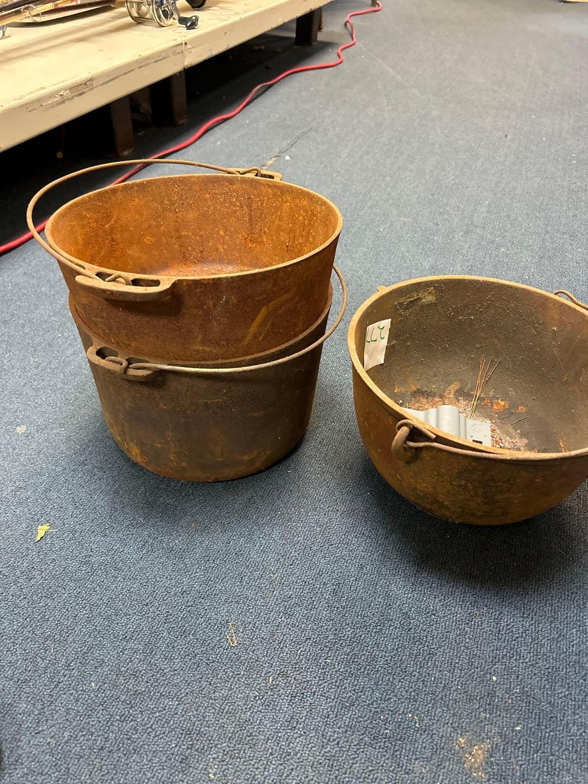 3 cast iron pots approximately 8 to 9 inches tall