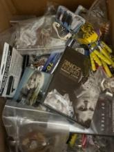 large box of miscellaneous pens, keychains DVD bottle openers and more