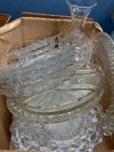 A lot of glass platters cake plates candlesticks dishes sugar bowls etc.