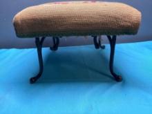 antique needlepoint bench with cast-iron hook as legs