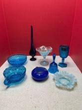 Blue glassware, including Fostoria, art glass ashtray, Fenton bell, and swung vase