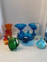 Colorful glassware, including Fenton ruffled vases