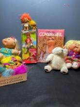 miscellaneous dolls and stuffed animals, including Coca-Cola, Barbie, Cabbage Patch, dolls, and My
