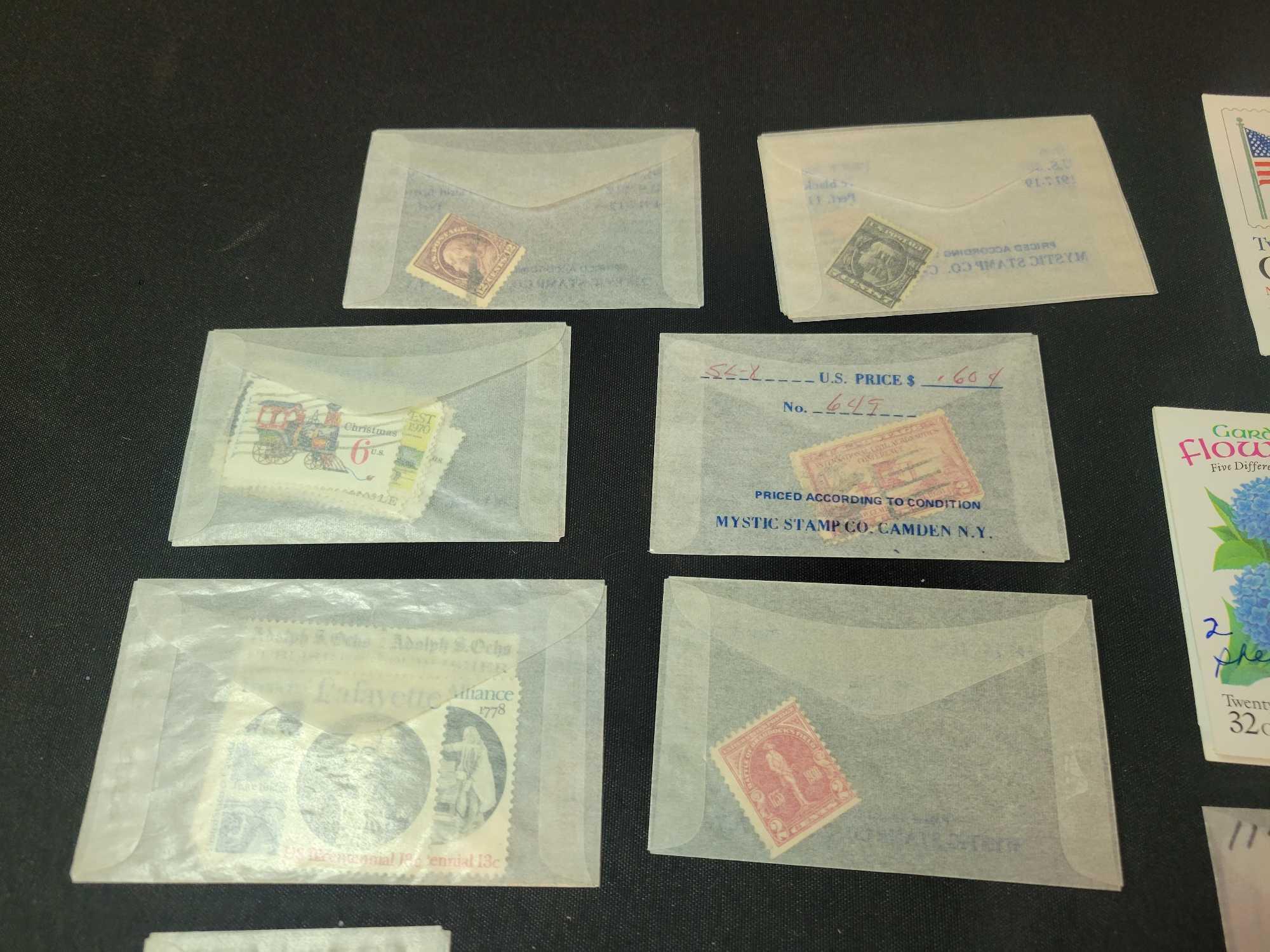 Unexploded and open USPS booklets, singles in glassines