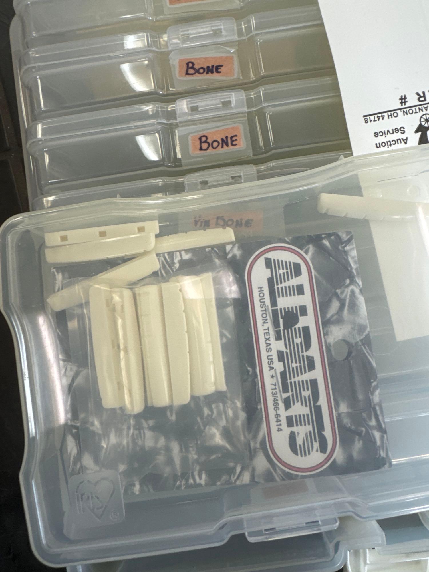 Assorted guitar nuts, and large box of strings