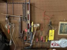 Wall of tools, screwdrivers, saws, pipe wrenches