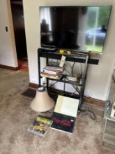 Vizio TV, wire stand, books, lamp