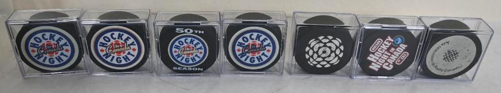 Seven Collector Hockey Pucks