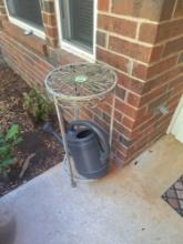 metal plant stand, plastic water can