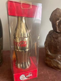 collectible gold Coca-Cola bottle. (upstairs)