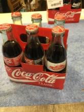 vintage six piece Coca-Cola bottles with carrying case, miscellaneous advertisements