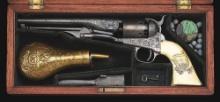 (A) FACTORY ENGRAVED AND CASED COLT MODEL 1861 NAVY PERCUSSION REVOLVER WITH CARVED IVORY GRIPS.