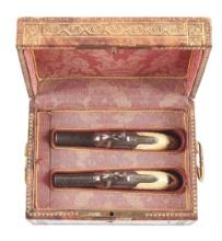 (A) CASED PAIR OF GOLD INLAID BELGIAN MUFF PISTOLS WITH CARVED IVORY GRIPS.