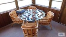 Rattan glass top table and four roll about chairs