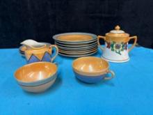 Collection of lusterware creamer covered pot cup saucers plates